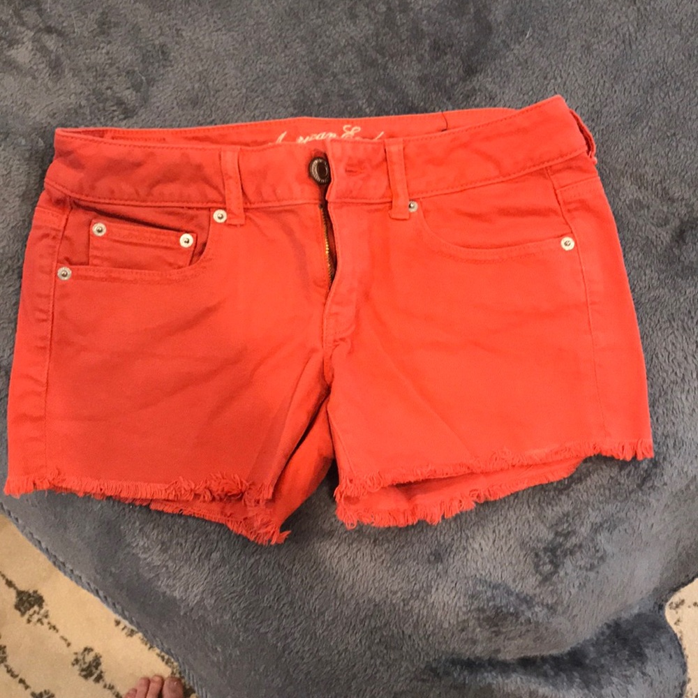 Red ripped jean shorts